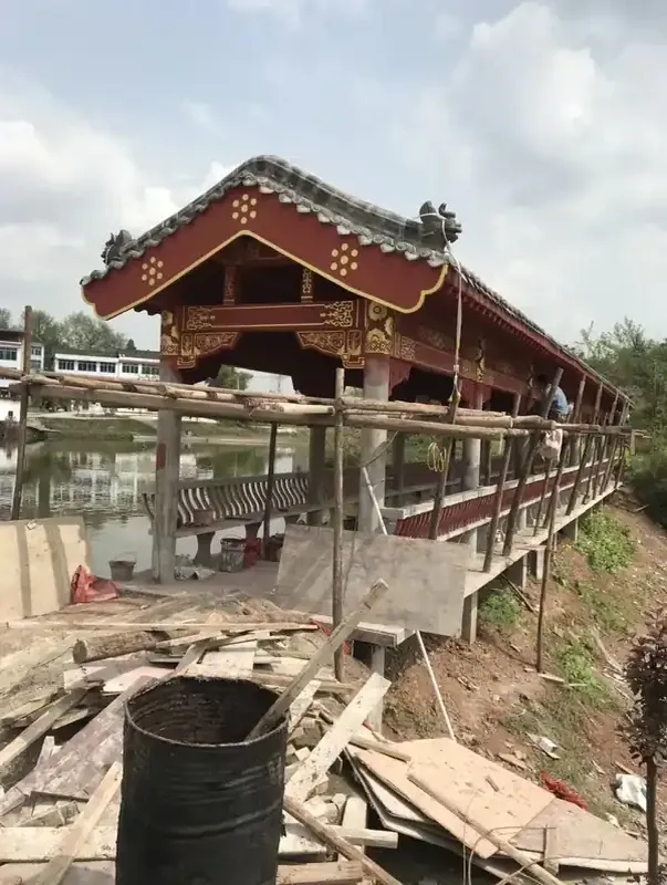 仿古风雨桥廊桥施工中景区古建廊桥红色柱子彩绘灰色瓦顶古建亭廊牌坊水榭户外景观木质结构传统工艺-古建亭廊牌坊水榭定制厂家